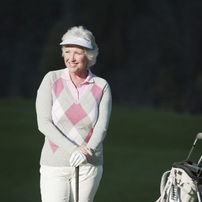 woman standing on green course
