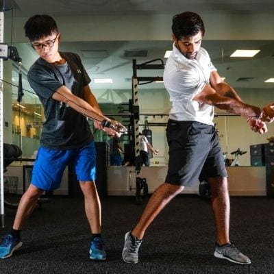 student and instructor practicing at the gym