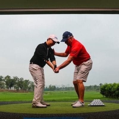 instructor and student on a golf course